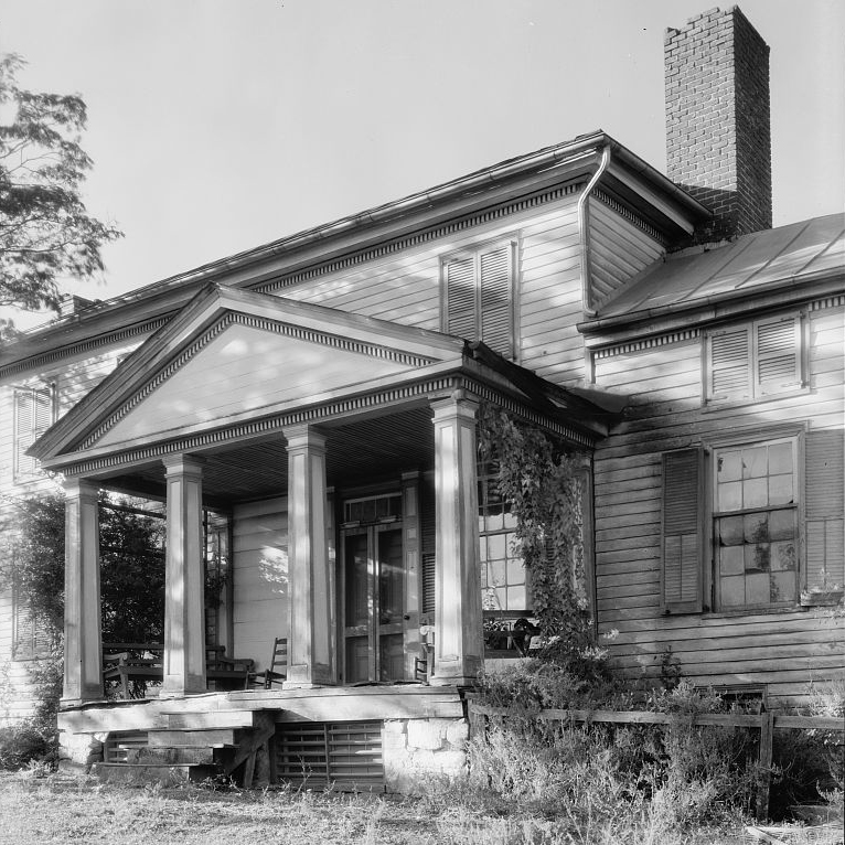 Historic black and white image taken by Frances Benjamin Johnston, of a boarded up burned house in Brown's Cove, Virginia.