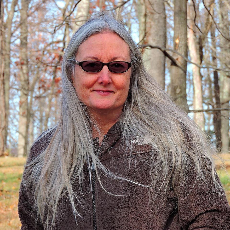 Portrait of a woman standing in a forest. 