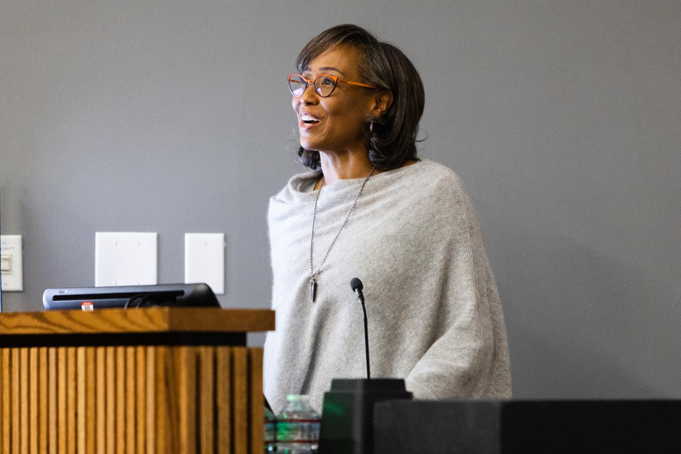 Smiling woman standing at podium