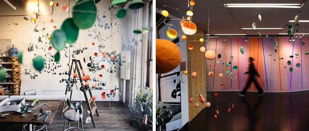 Two images, left close up of installation of hanging paper forms; right, installation with mural in background