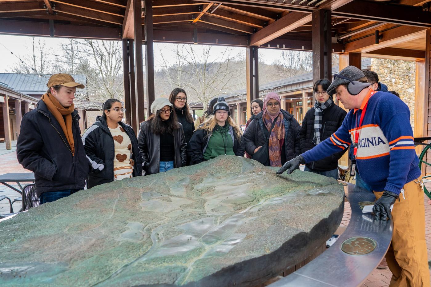 UVA SAH students attended a talk with a person showing a large topographic table