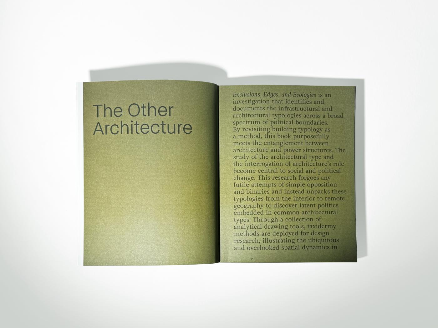 An open book showing olive green pages overlaid with black text about architecture.