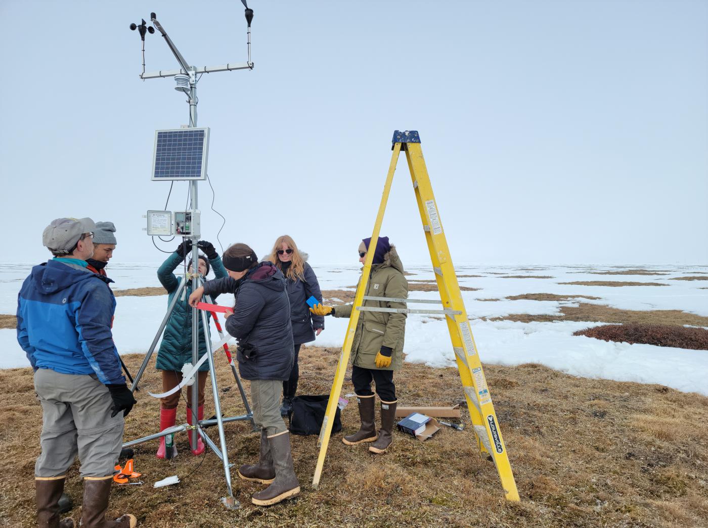 Arctic Design Group researcher setting up monitoring equipment in Alaska