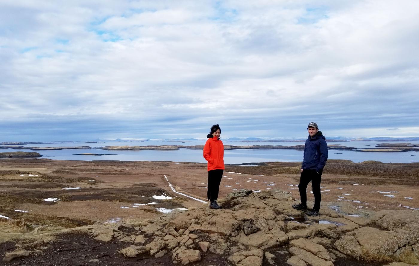 Leena Cho and Matthew Jull of Arctic Design Group standing on rocks in Alaskan landscape