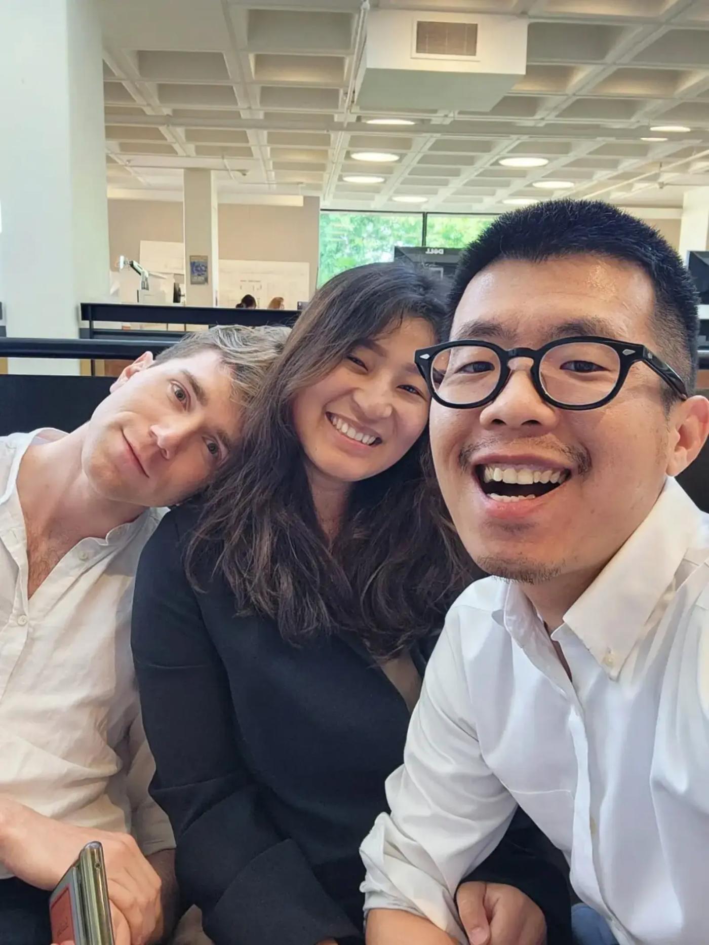Three UVA School of Architecture students seated together with happy faces.